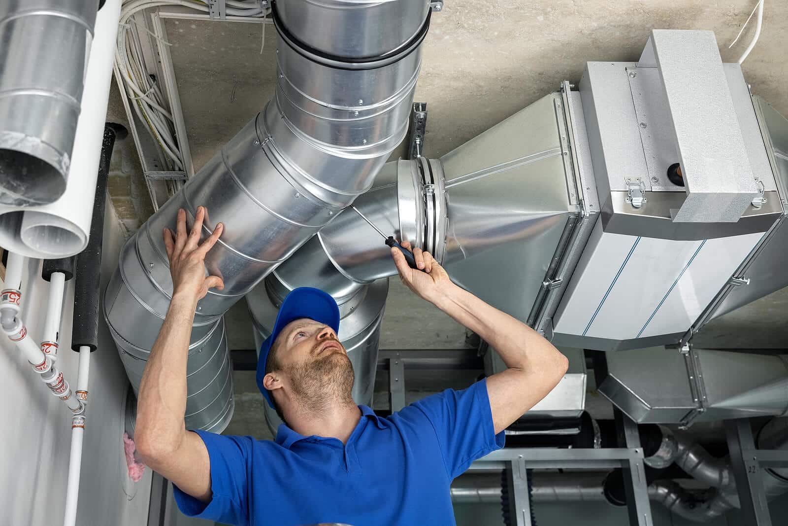 HVAC technician inspecting and repairing air ducts in Santa Paula