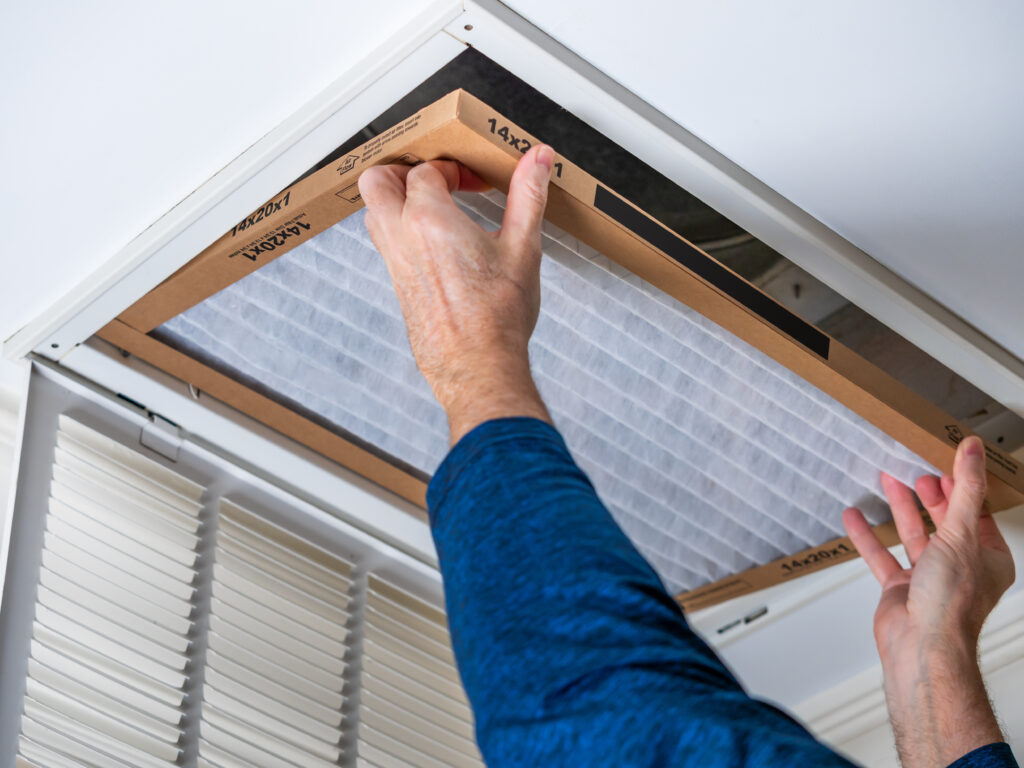 HVAC technician replacing a home air filter in Santa Paula