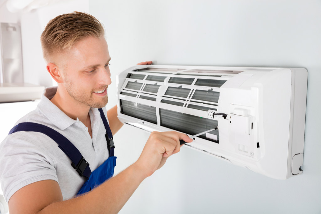 HVAC technician maintaining a ductless air conditioner in Santa Paula