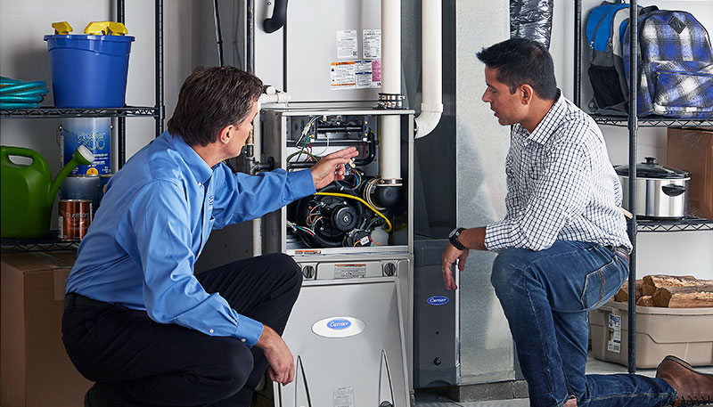 Technician evaluating a furnace for repair or replacement in Santa Paula