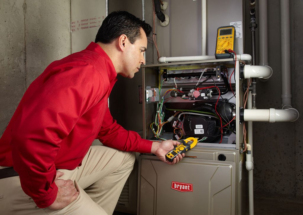 Heating technician diagnosing a furnace repair in Santa Paula