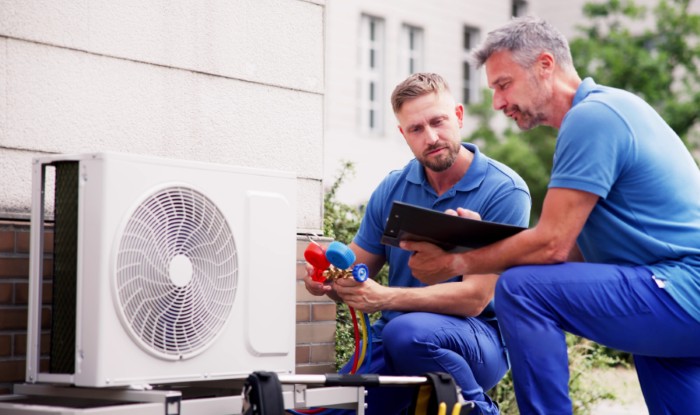 HVAC technicians installing an outdoor air conditioning unit in Santa Paula