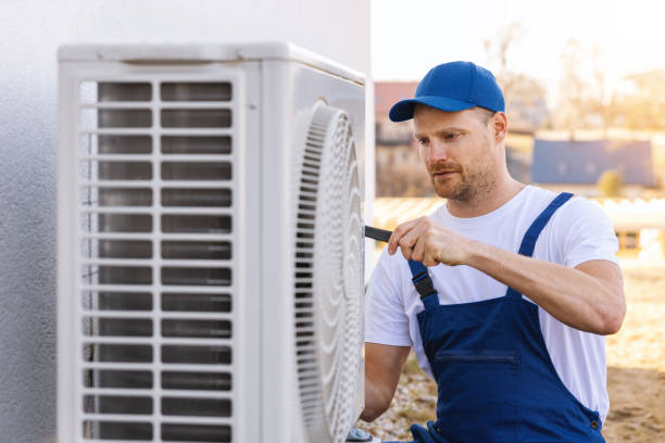 HVAC technician servicing an outdoor air conditioner in Santa Paula