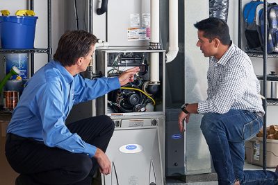 Furnace Repair or Replacement Santa Paula Technician evaluating a furnace for repair or replacement in Santa Paula